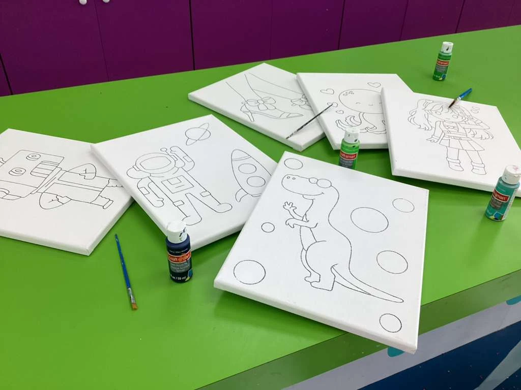 Assorted pre-drawn canvases featuring a robot, astronaut, dinosaur, octopus, character, and bow heels