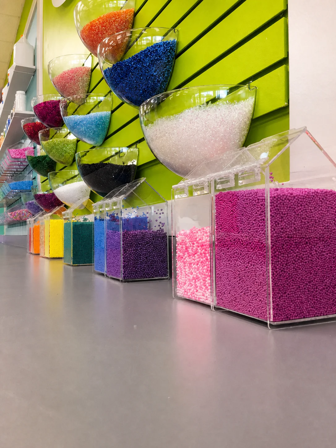 Foam beads and other slime texture add-ins displayed in clear bins